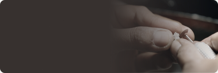 A jeweler setting a diamond by hand